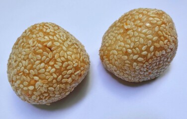 Onde-onde is a traditional cake sprinkled with sesame seeds on the surface and filled with green beans inside. Traditional Indonesian cake.