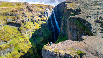 Glymur waterfall Iceland cascading down lush cliffs in Icelands landscape