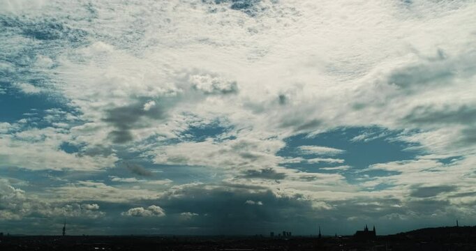Wide 4K Time Lapse over Prague Horizon with Layered Fast Moving Clouds Racing Above the Silhouettes of Prague Castle Žižkov Transmitter and Petř&iacute;n Revealing Dynamic Skies and Urban Landmark Profile