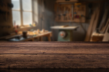 Wooden workbench in a workshop with tools and daylight streaming through the window