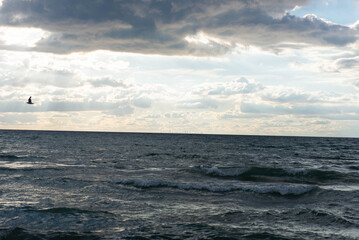 Distant skyline of Chicago over Lake Michigan under dramatic clouds
