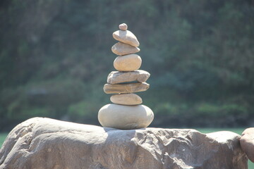 Cairn with river in the background, stacked stones, peaceful setting, serene landscape 5