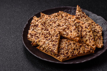 Crispbread, thin bread with seeds and grains, a baked cracker. Crispbread with sesame seeds