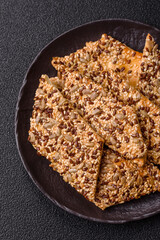 Crispbread, thin bread with seeds and grains, a baked cracker. Crispbread with sesame seeds