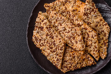 Crispbread, thin bread with seeds and grains, a baked cracker. Crispbread with sesame seeds