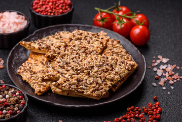 Crispbread, thin bread with seeds and grains, a baked cracker. Crispbread with sesame seeds