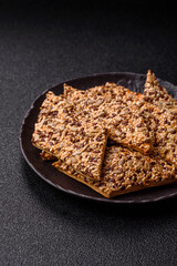 Crispbread, thin bread with seeds and grains, a baked cracker. Crispbread with sesame seeds