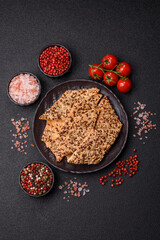 Crispbread, thin bread with seeds and grains, a baked cracker. Crispbread with sesame seeds
