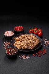 Crispbread, thin bread with seeds and grains, a baked cracker. Crispbread with sesame seeds
