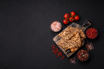 Crispbread, thin bread with seeds and grains, a baked cracker. Crispbread with sesame seeds