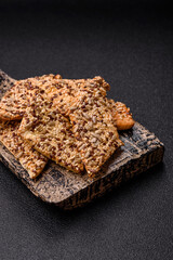 Crispbread, thin bread with seeds and grains, a baked cracker. Crispbread with sesame seeds