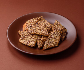 Crispbread, thin bread with seeds and grains, a baked cracker. Crispbread with sesame seeds