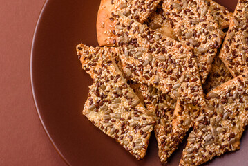 Crispbread, thin bread with seeds and grains, a baked cracker. Crispbread with sesame seeds