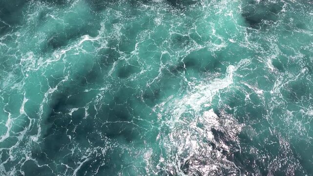 Pearl-green water boils overboard after passing a large ship. Bali Sea-Flores Sea