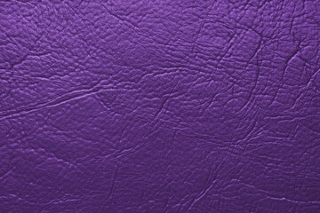 Close up, macro texture of purple glossy natural genuine leather, leatherette structure, artifical skin surface with embossed pattern. Background, wallpaper, backdrop