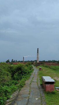 Scenic Brick Kiln Landscape with Smokestacks under Overcast Sky 4k video