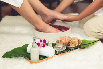 Man indulges in blissful foot massage at luxurious spa salon while masseur give reflexology therapy...