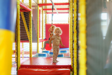 Children playing and exploring in an indoor play area designed for adventure and fun in bright colors and safe environment