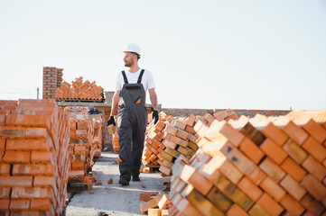 Construction worker man in work clothes and a construction helmet. Portrait of positive male...