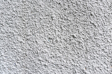 Rough white textured wall provides a detailed closeup of its uneven surface, suitable for...