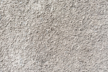 Rough white textured wall provides a detailed closeup of its uneven surface, suitable for...