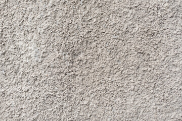 Rough white textured wall provides a detailed closeup of its uneven surface, suitable for...