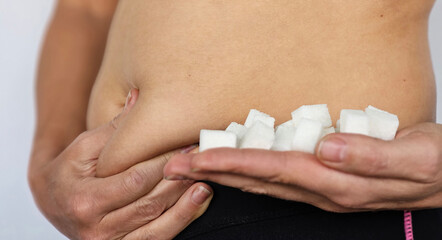 Woman Holding Small Block of Sugar in Stomach
