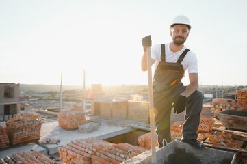 Construction worker in uniform and safety equipment have job on building