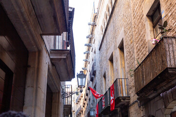 Narrow street with catalan flags flying in barcelona's gothic quarter