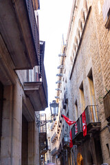 Narrow street with catalan flags flying in barcelona's gothic quarter