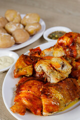 Close-Up of Roasted Chicken Pieces with Boiled Potatoes in the Background