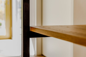 Fototapeta premium Close-Up of Metal Shelf with Wooden Boards in Minimal Corner