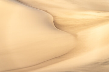 Golden sand dunes with swirling textures