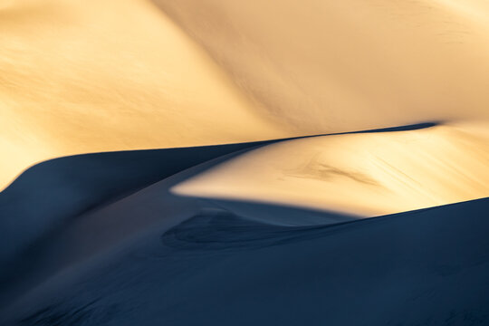 Golden sand dunes with intricate shadow patterns