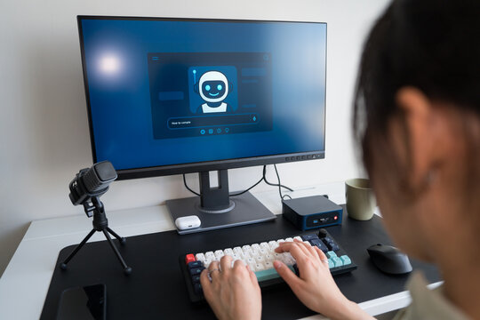 Young professional using AI robot assistant at home