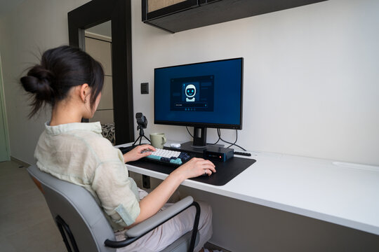 Young professional using robot assistant in home office