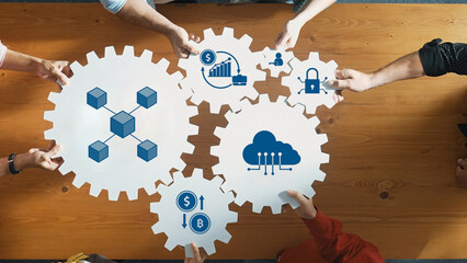 Engaging view of hands assembling gear icons that symbolize business processes, data flow, finance, and technology in a collaborative workspace focused on innovation. Amity