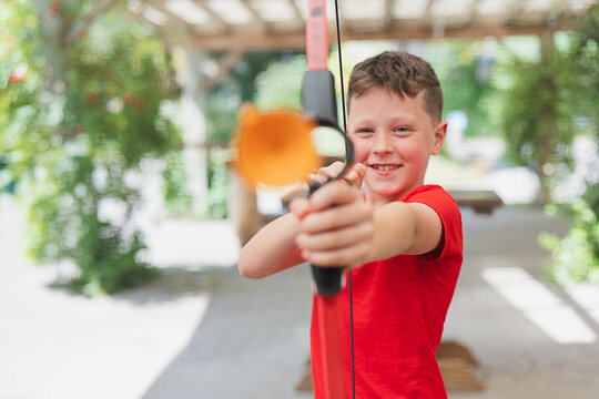 Kid in action enjoying outdoor archery adventure