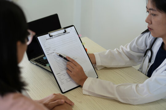 Young professional female doctor taking notes in journal, physician therapist practitioner filling and explaining medical documents, clipboard, patient form, illness history, prescription in clinic.	 - Powered by Adobe