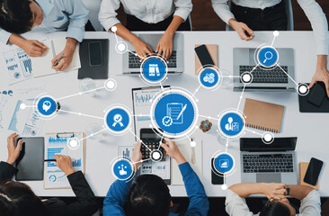 Top view analyst team utilizing BI Fintech to analyze financial data at table in meeting room....