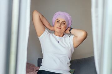 Peaceful woman with lavender turban enjoying morning light