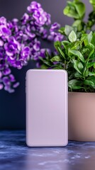 Sleek smartphone against lush greenery with vibrant purple flowers in modern setting