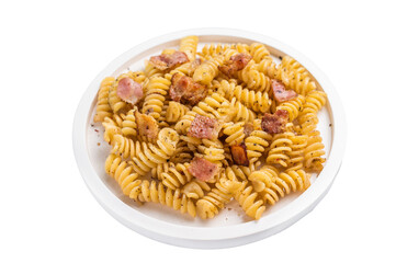 Fusilli carbonara pasta topped with crispy bacon bits and parmesan  cheese  in a plate isolated on white background