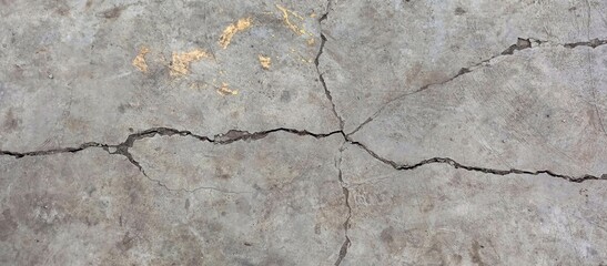 Cracked Concrete Floor with Yellow Paint Remnants