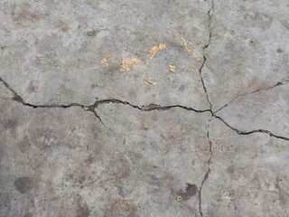 Cracked Concrete Floor with Yellow Paint Remnants