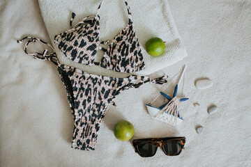 Leopard swimsuit, towel, slippers, glasses and other things for a seaside vacation