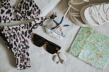 Leopard swimsuit, towel, slippers, glasses, navigation map and other things for a seaside vacation