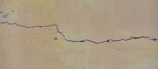 Large Crack in Aged Yellow Painted Wall
