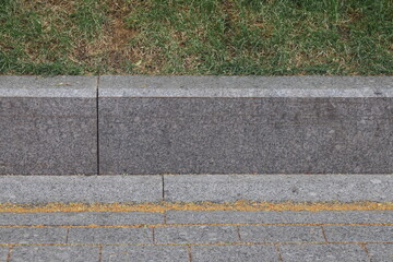 granite curb on green lawn, cobblestone pavement, gray curbstone, 2