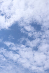 Obraz premium White clouds against the blue sky. Sky background. Summer. Landscape. Soft white clouds against the blue sky. Calm and serene atmosphere. White fluffy clouds